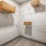 spacious walk-in closet with shelving and light