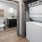 stacked washer/dryer closet in bright hallway