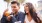 young couple sit at an outdoor table with plastic cups of beer at local restaurant